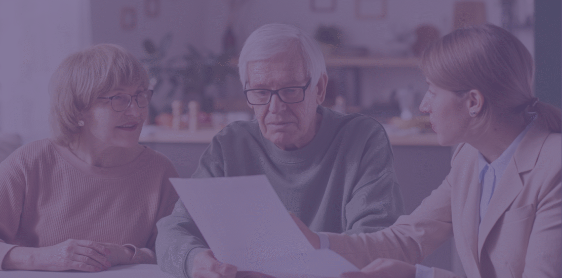 Old couple looking at a Will with an adviser